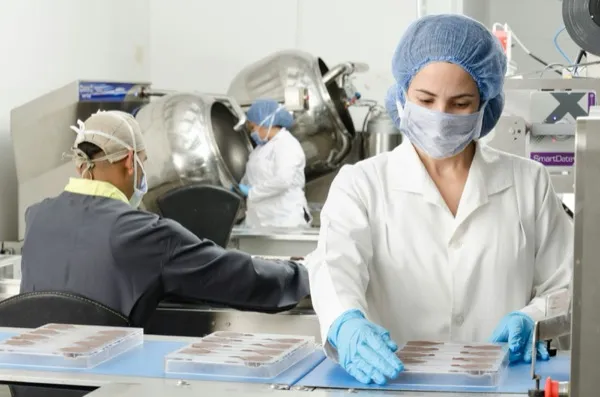 Pharma workers on packaging line