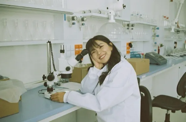Scientist at microscope — company founding