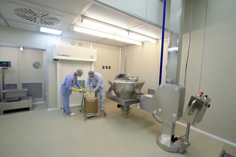 Cleanroom workers packaging pharmaceutical-grade ingredients